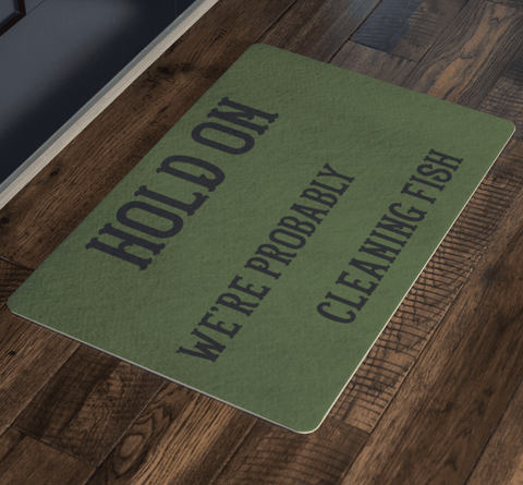 Image of Hold On We're Probably Cleaning Fish | Solid Color Background Doormat
